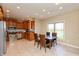 Open-concept kitchen with stainless appliances, tile floors, and a dining area with backyard views at 2838 Violet W Ct, Columbus, IN 47201