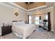 Comfortable main bedroom with tray ceilings, two windows, and a dedicated workspace at 2838 Violet W Ct, Columbus, IN 47201
