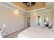 Spacious main bedroom featuring tray ceilings, a ceiling fan, and ample natural light at 2838 Violet W Ct, Columbus, IN 47201