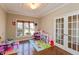 Bright playroom featuring hardwood floors, decorative tray ceiling, and natural light at 2838 Violet W Ct, Columbus, IN 47201
