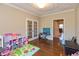 Spacious playroom boasting hardwood floors, a tray ceiling, and easy access to other rooms at 2838 Violet W Ct, Columbus, IN 47201