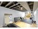 Spacious basement with exposed ceiling beams, white walls, and wood flooring, providing a flexible living space at 2951 E 62Nd St, Indianapolis, IN 46220
