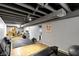Open basement area featuring workout equipment, light wood flooring, and an open ceiling concept for versatile usage at 2951 E 62Nd St, Indianapolis, IN 46220