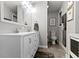 Bright bathroom featuring a double vanity, mirror, and artwork at 2951 E 62Nd St, Indianapolis, IN 46220