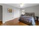 Bedroom featuring a bed, closet, and hardwood floors at 2951 E 62Nd St, Indianapolis, IN 46220