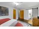 Bedroom features hardwood floors, ceiling fan, and barn door to ensuite bathroom at 2951 E 62Nd St, Indianapolis, IN 46220