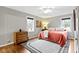 Cozy bedroom with hardwood floors, ceiling fan, and two windows at 2951 E 62Nd St, Indianapolis, IN 46220