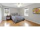 Light-filled bedroom featuring a ceiling fan and hardwood floors at 2951 E 62Nd St, Indianapolis, IN 46220