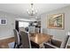 Elegant dining room featuring wood table, seating for six, stylish chandelier, and classic decor and built-in bar at 2951 E 62Nd St, Indianapolis, IN 46220