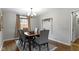 Formal dining room features hardwood floors, neutral paint, modern chandelier, and an area rug at 2951 E 62Nd St, Indianapolis, IN 46220