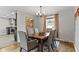 Formal dining room features hardwood floors, neutral paint, modern chandelier, and an area rug at 2951 E 62Nd St, Indianapolis, IN 46220