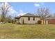Charming stone home with a well-maintained lawn and mature trees, offering curb appeal and a welcoming atmosphere at 2951 E 62Nd St, Indianapolis, IN 46220