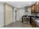 Bright kitchen featuring stainless steel range hood, stone countertops, stainless appliances, and neutral colored cabinetry at 2951 E 62Nd St, Indianapolis, IN 46220
