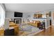 Cozy living room with fireplace, flat screen tv, stylish furniture, and view to kitchen at 2951 E 62Nd St, Indianapolis, IN 46220