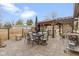 Inviting patio area with an outdoor dining table and chairs, a built-in grill, and pergola for outdoor entertaining at 2951 E 62Nd St, Indianapolis, IN 46220