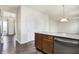 Kitchen island featuring dark wood cabinets and stainless steel dishwasher at 3236 Springs Way Dr, Bargersville, IN 46106