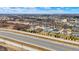 An aerial view showcases a charming neighborhood with single-Gathering homes, trees, and proximity to a highway at 3924 Bear Creek Way, Carmel, IN 46074
