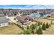 Aerial view of a brick house with a cozy backyard fire pit and manicured trees at 3924 Bear Creek Way, Carmel, IN 46074