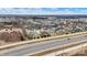 A sprawling neighborhood is captured in this aerial view, showcasing homes, tree coverage, and the location near a highway at 3924 Bear Creek Way, Carmel, IN 46074