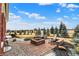 Brick fire pit with a seating area in the backyard at 3924 Bear Creek Way, Carmel, IN 46074