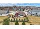 A brick home features a cozy backyard with a patio and a lovely fire pit area surrounded by lush landscaping at 3924 Bear Creek Way, Carmel, IN 46074