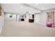 Large finished basement with carpet flooring, featuring a home bar and open area for recreational activities at 3924 Bear Creek Way, Carmel, IN 46074