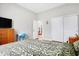Bedroom with hardwood floors, a TV, and closets at 3924 Bear Creek Way, Carmel, IN 46074