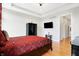Spacious bedroom featuring hardwood floors, a tray ceiling, a mounted flat screen TV, and a modern closet at 3924 Bear Creek Way, Carmel, IN 46074