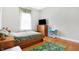 Bedroom with hardwood floors, light walls, desk, and a TV on a dresser at 3924 Bear Creek Way, Carmel, IN 46074