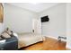 Bedroom with hardwood floors, light walls, and a TV at 3924 Bear Creek Way, Carmel, IN 46074