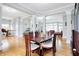 Open-concept dining room with hardwood floors, white columns, and views of the living area at 3924 Bear Creek Way, Carmel, IN 46074