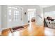 Bright foyer with hardwood floors, a staircase with a dark banister, and double doors leading to the outside at 3924 Bear Creek Way, Carmel, IN 46074