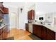 Modern kitchen featuring granite countertops, stainless steel appliances, and cherry wood cabinets at 3924 Bear Creek Way, Carmel, IN 46074