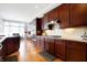 Stylish kitchen with cherry cabinets, stainless steel appliances, and a view to breakfast nook at 3924 Bear Creek Way, Carmel, IN 46074