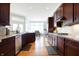 Gourmet kitchen with granite countertops, stainless steel appliances, and a view to the breakfast nook at 3924 Bear Creek Way, Carmel, IN 46074