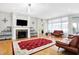 Open living room with fireplace, hardwood floors, and comfortable seating at 3924 Bear Creek Way, Carmel, IN 46074
