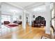 Open-concept living area with hardwood floors, leather sofas, and a dining area in background at 3924 Bear Creek Way, Carmel, IN 46074