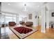 Bright living room with hardwood floors, leather sofas, and a decorative chandelier at 3924 Bear Creek Way, Carmel, IN 46074