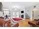 Spacious living room with hardwood floors, a fireplace, and an open layout to the dining area at 3924 Bear Creek Way, Carmel, IN 46074