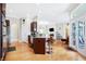 Open concept kitchen flowing into the living room, featuring a granite island and stainless appliances at 3924 Bear Creek Way, Carmel, IN 46074