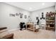 Comfortable office space with beige carpet, filled with a wooden desk, sofa, and well-stocked bookshelf at 3924 Bear Creek Way, Carmel, IN 46074