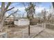Backyard featuring a detached garage, fence, large tree, patio, and picnic table at 4249 Dubarry Rd, Indianapolis, IN 46226