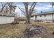 Backyard featuring a picnic table, detached garage, large tree and bare grass at 4249 Dubarry Rd, Indianapolis, IN 46226