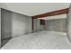 Spacious unfinished basement with concrete block walls, carpeting, and painted beams at 4249 Dubarry Rd, Indianapolis, IN 46226
