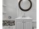 Modern bathroom featuring a stylish round mirror and vanity with tiled accents at 4249 Dubarry Rd, Indianapolis, IN 46226