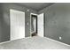 Bedroom featuring gray walls, carpet, standard closet and a view into another room at 4249 Dubarry Rd, Indianapolis, IN 46226