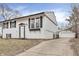 Charming two-story home with a white exterior, black shutters, and a detached one car garage at 4249 Dubarry Rd, Indianapolis, IN 46226