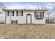 Charming two-story home with a white exterior, black shutters, and a well-manicured lawn at 4249 Dubarry Rd, Indianapolis, IN 46226