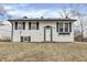 Two-story house with a black roof, white siding and black shutters at 4249 Dubarry Rd, Indianapolis, IN 46226