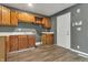 Traditional kitchen featuring wood cabinets, gray walls, and a white door at 4249 Dubarry Rd, Indianapolis, IN 46226